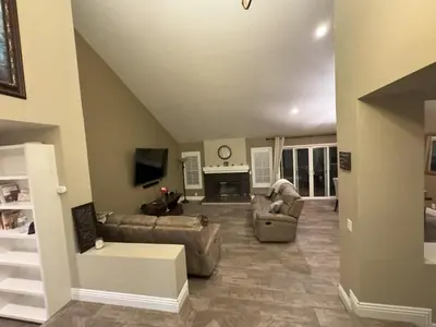 a living room with two couches and a fireplace at Riverside Views & Pool Retreat in Riverside