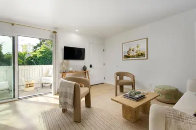 a living room with a couch and a table at Outdoor Spaces and Coastal Sanctuary in Summerland