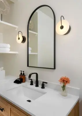 a bathroom with a white sink and a mirror at Sunny Getaway and 10 Min to SB in Summerland