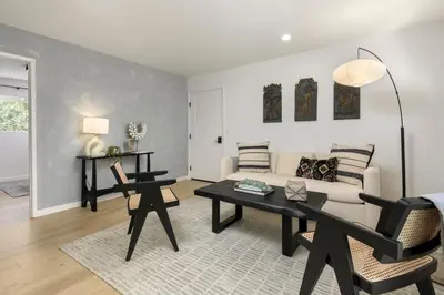 a living room with a couch and a table at Sunny Getaway and 10 Min to SB in Summerland