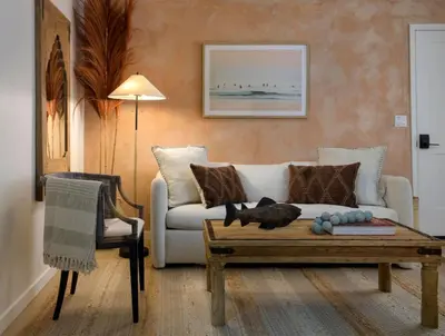 a living room with a cat laying on a coffee table at Bali Home and SB Beaches in Summerland