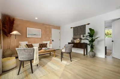 a living room with a couch and a table at Bali Home and SB Beaches in Summerland