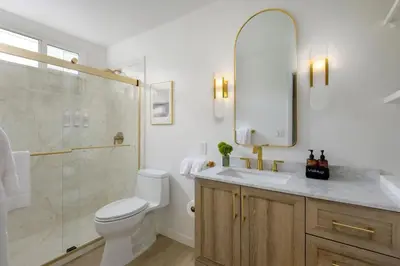 a bathroom with a toilet and a shower and a sink at Bali Home and SB Beaches in Summerland