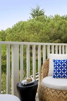 a chair on a porch with a plate on a table at Group-Friendly and Tranquil Oasis in Summerland
