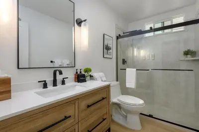 a bathroom with a toilet and a sink and a shower at Group-Friendly and Tranquil Oasis in Summerland