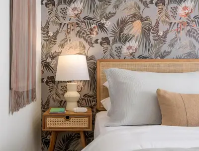 a bedroom with a bed with a lamp on a night stand at Group-Friendly and Tranquil Oasis in Summerland