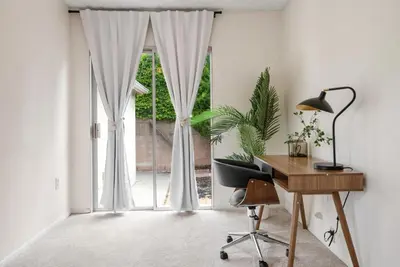 an office with a desk and a sliding glass door at Vintage Vibes Near Airport Games Sleeps 8 in Long Beach