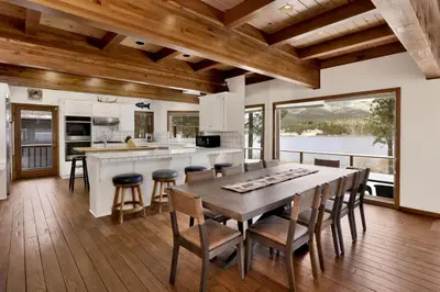 a kitchen with a table and some chairs and a counter at Bear Lake Lodge Lakefront Incredible Lake House Chalet in Big Bear Lake
