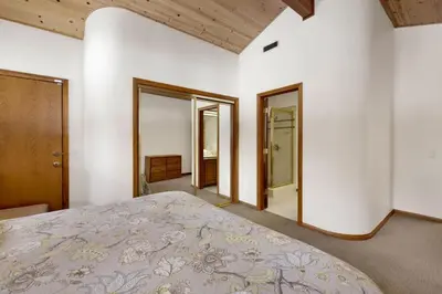a bedroom with a large bed and two mirrors at Bear Lake Lodge Lakefront Incredible Lake House Chalet in Big Bear Lake