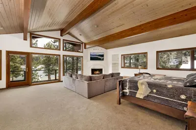 a bedroom with a bed and a couch and a fireplace at Bear Lake Lodge Lakefront Incredible Lake House Chalet in Big Bear Lake