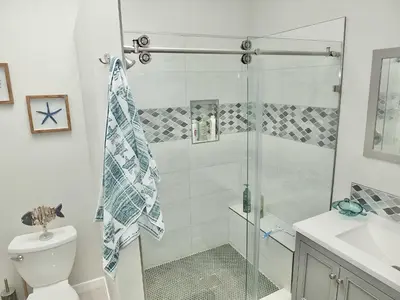 a bathroom with a shower and a toilet and a sink at Beach & Bay Retreat - Full of Amenities in Long Beach
