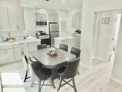 a kitchen with a table and chairs in it at Beach & Bay Retreat - Full of Amenities in Long Beach