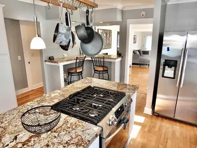 a kitchen with a stove and a counter top at Beach City Craftsman - Walk to Beach in Long Beach