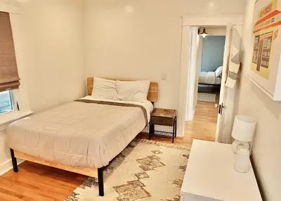 a small bedroom with a bed and a table at Beach City Craftsman - Walk to Beach in Long Beach