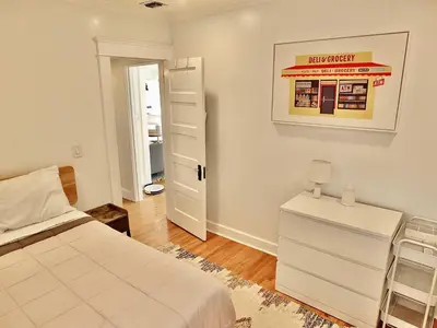 a bedroom with a bed and a picture of a gas station at Beach City Craftsman - Walk to Beach in Long Beach