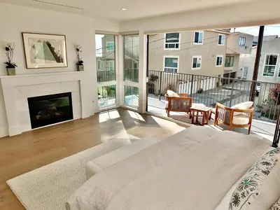 a living room with a bed and a fireplace at Beach Paradise - Stunning 3-Story in Long Beach in Long Beach