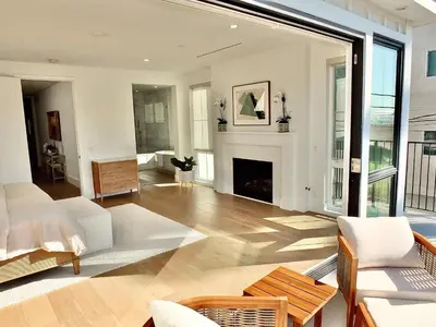 a living room with a fireplace and a couch at Beach Paradise - Stunning 3-Story in Long Beach in Long Beach
