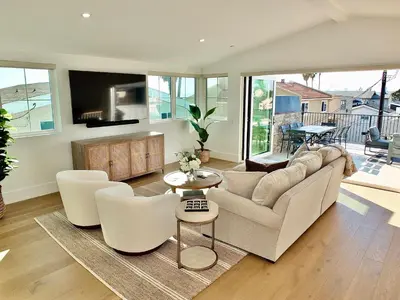 a living room with a couch and chairs and a table at Beach Paradise - Stunning 3-Story in Long Beach in Long Beach