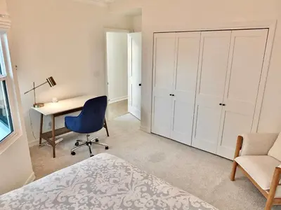 a bedroom with a bed and a desk and a chair at Beachfront Estate - LB Peninsula in Long Beach