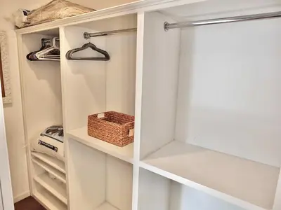 a white closet with a basket in it at Bellflower Breeze - Charming 3 BDR in Long Beach in Long Beach