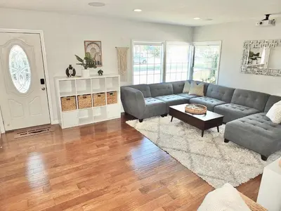 a living room with a couch and a table at Bellflower Breeze - Charming 3 BDR in Long Beach in Long Beach