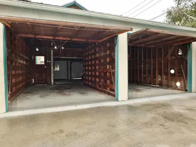an empty garage with a brick wall at Belmont Heights Retreat - Stunning Gardens in Long Beach