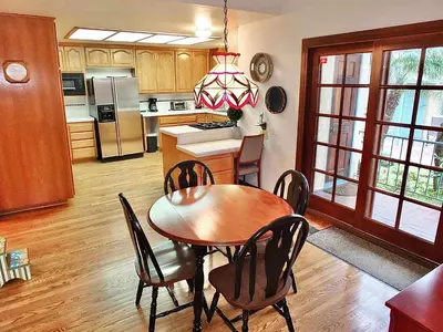 a kitchen and dining room with a table and chairs at Belmont Heights Retreat - Stunning Gardens in Long Beach