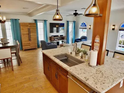 a kitchen with a sink and a living room at Belmont Shore Beach House - Incredible Oceanfront Views in Long Beach