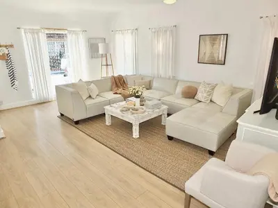 a living room with a couch and a table at Steps to Beach & Alamitos Bay on LB Peninsula in Long Beach