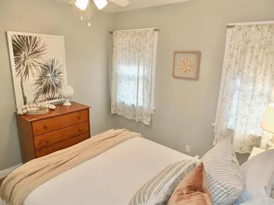 a bedroom with a bed and a dresser and window at Steps to Beach & Alamitos Bay on LB Peninsula in Long Beach