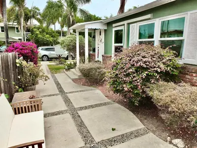 a walkway in front of a house with a bench at Greenbelt Guesthouse - Unlimited Peace & Privacy Golf Bowling Green & More in Long Beach