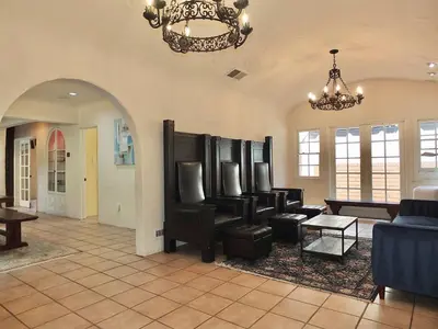 a living room with couches and a chandelier at La Brisa - One Block from the Beach in Long Beach