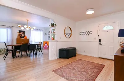 a living room with a table and a dining room at Immaculate 3BDR Bungalow - 5-Min Walk to Beach in Long Beach