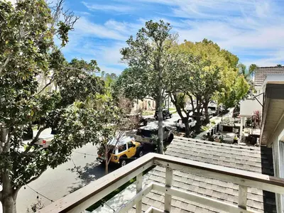 a view of a city street with a yellow van at Park Avenue Beach Paradise - Chic & Secluded 4 BDR in Long Beach