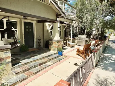 a porch of a house with a fence at Park Avenue Beach Paradise - Chic & Secluded 4 BDR in Long Beach