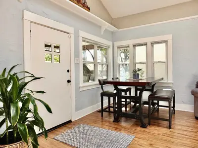 a dining room with a table and chairs and a door at Park Avenue Beach Paradise - Chic & Secluded 4 BDR in Long Beach