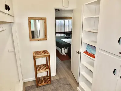 a small room with a closet and a bedroom at Sand Sun & Second - Charming Studio within Walking Distance to Beach in Long Beach
