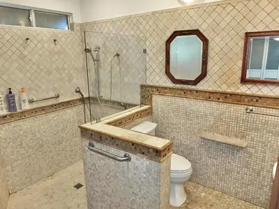 a bathroom with a toilet and a shower and a sink at The Belmont Beach Bungalow - Pool & Hot tub in Long Beach