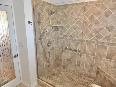 a bathroom with a shower with a glass door at The Belmont Beach Bungalow - Pool & Hot tub in Long Beach