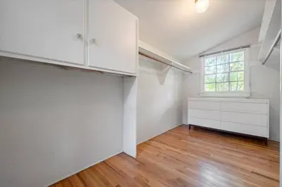 an empty room with a window and white cabinets at The Otsego Hideaway in Los Angeles