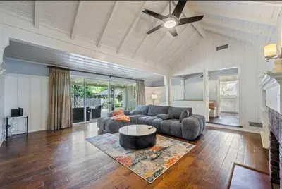 a living room with a couch and a ceiling fan at The Otsego Hideaway in Los Angeles