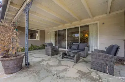 a porch with chairs and a couch and a table at The Otsego Hideaway in Los Angeles