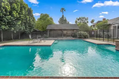 a swimming pool with blue water in front of a house at The Otsego Hideaway in Los Angeles