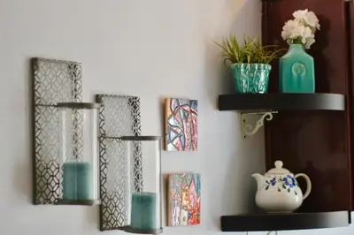 a wall with three shelves with vases and a pitcher at Sweet Dreams B&B LA in Sherman Oaks