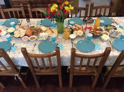 a table with blue plates and food on it at Sweet Dreams B&B LA in Sherman Oaks