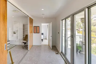 an office with sliding glass doors and a hallway at Walk to Sunset Strip Modern Home in WeHo Hills! in Los Angeles