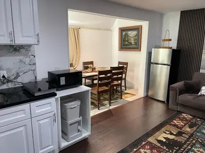 a kitchen and living room with a table with a microwave at Cozy 2 BR Apartment Glendale in Glendale