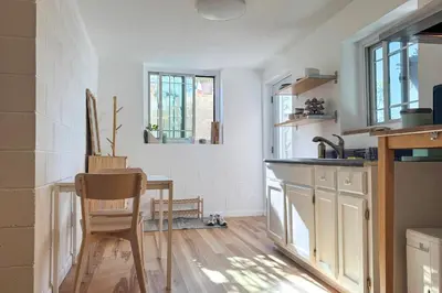 a kitchen with a sink and a table with a chair at 5 Mi to Dtwn Los Angeles Apt with Outdoor Space! in Los Angeles