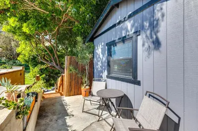 a patio with two chairs and a table next to a building at 5 Mi to Dtwn Los Angeles Apt with Outdoor Space! in Los Angeles
