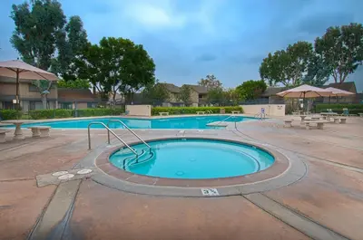 a large swimming pool with benches around it at Love Bug by Funtierland Vacation Rentals in Anaheim